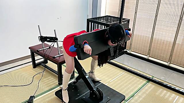 Chinese slave in costume has a fuck machine plowing her cunt