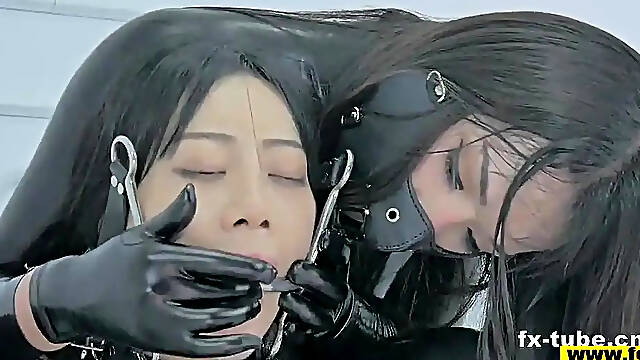 Latex Mistress Gags Slave Girl