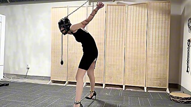 HH97-Asian girl, stockings, gagged, metal restraints, hands suspended, reaching orgasm via fully automated machine.